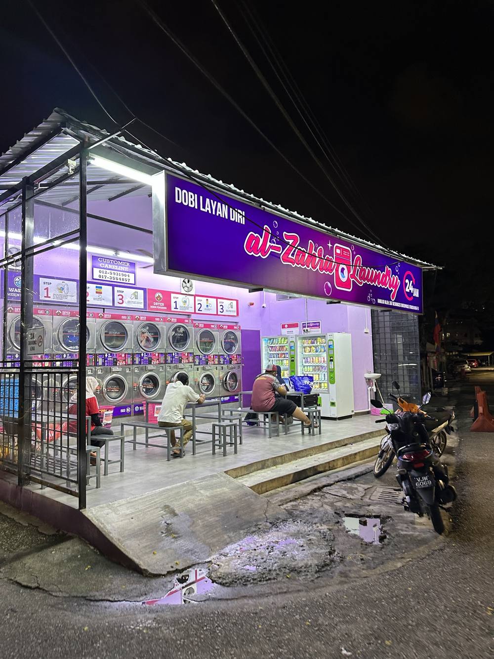 Al-Zahra Laundry glowing at night